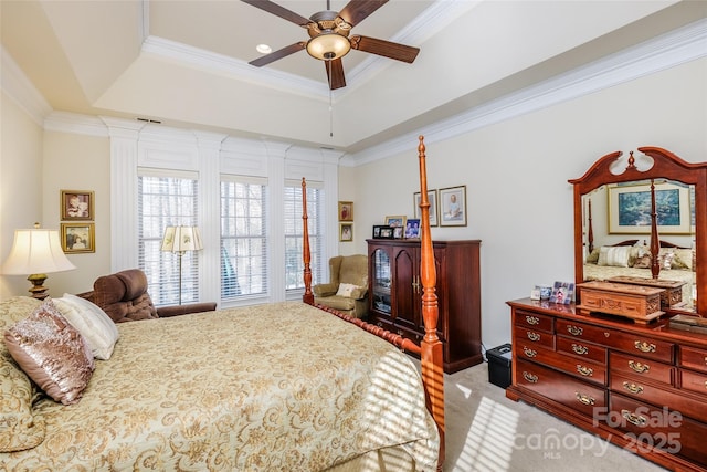 carpeted bedroom featuring a raised ceiling, crown molding, and ceiling fan