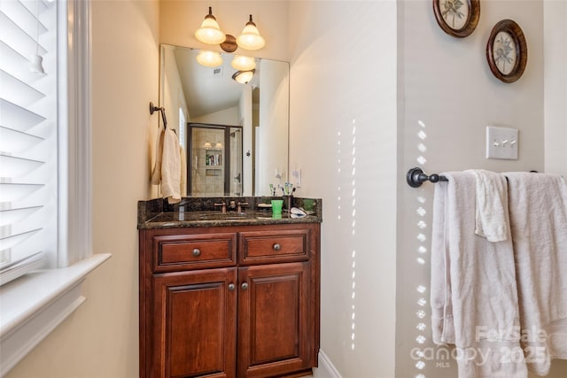 bathroom with vanity, lofted ceiling, and an enclosed shower