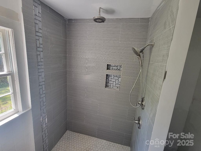 bathroom with tiled shower