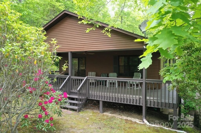 back of property featuring a wooden deck