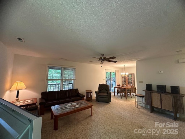 living room with ceiling fan with notable chandelier, carpet floors, and a textured ceiling