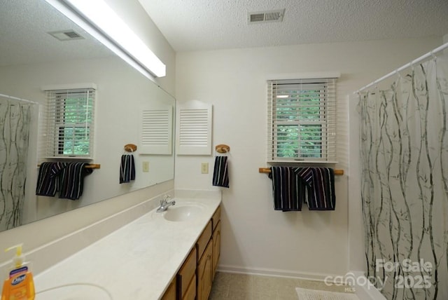 bathroom with vanity, a shower with shower curtain, and a wealth of natural light