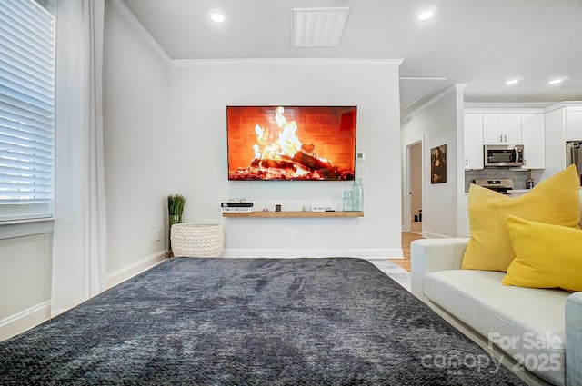 living room featuring hardwood / wood-style floors and ornamental molding