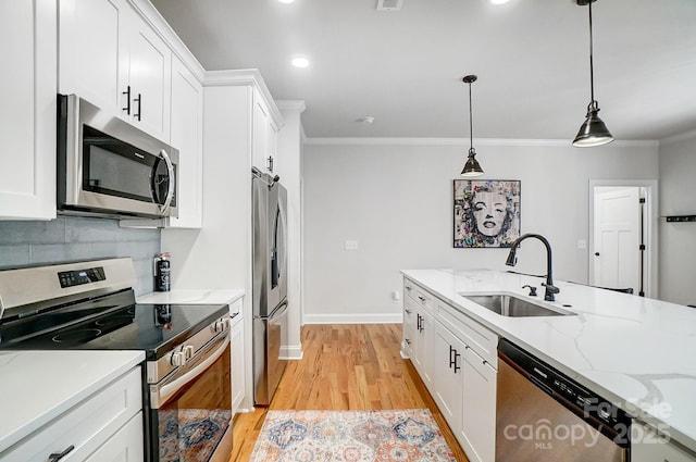 kitchen with white cabinetry, sink, and stainless steel appliances