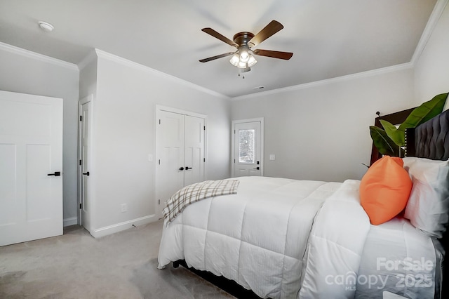 carpeted bedroom featuring ornamental molding and ceiling fan