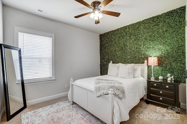 carpeted bedroom featuring multiple windows and ceiling fan