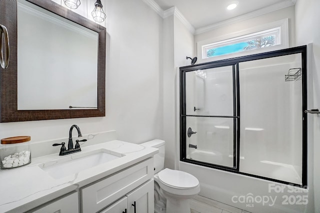 full bathroom with vanity, combined bath / shower with glass door, ornamental molding, and toilet