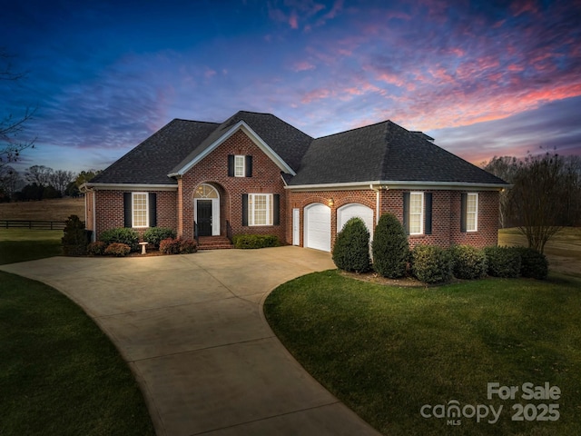 view of front of house featuring a garage and a lawn