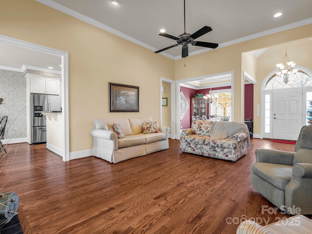 living room featuring crown molding, dark wood-type flooring, and ceiling fan with notable chandelier