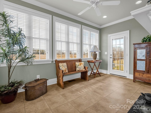 living area featuring light tile patterned flooring, ornamental molding, and a wealth of natural light