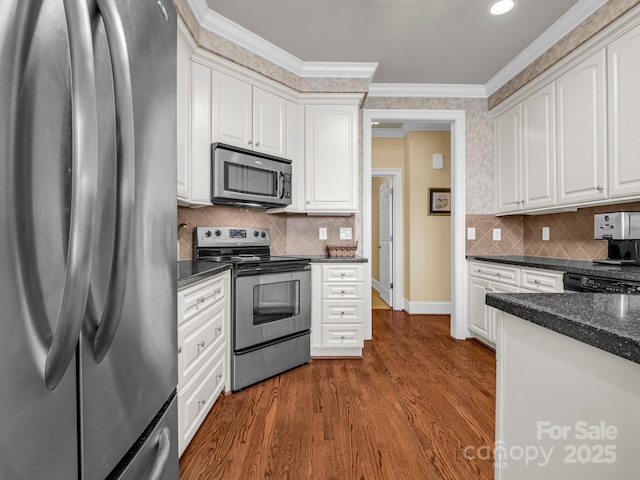 kitchen featuring white cabinetry, appliances with stainless steel finishes, crown molding, and dark hardwood / wood-style flooring