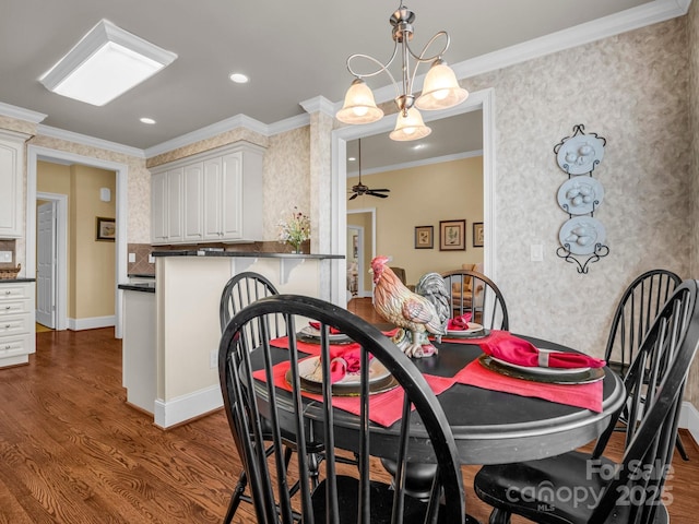 dining room with hardwood / wood-style flooring, ceiling fan, and ornamental molding