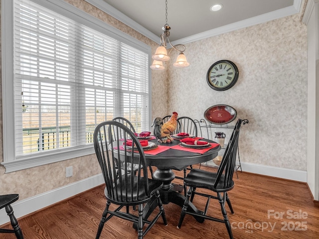 dining room with hardwood / wood-style flooring and ornamental molding