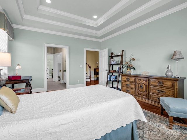 bedroom featuring a raised ceiling, ornamental molding, and wood-type flooring