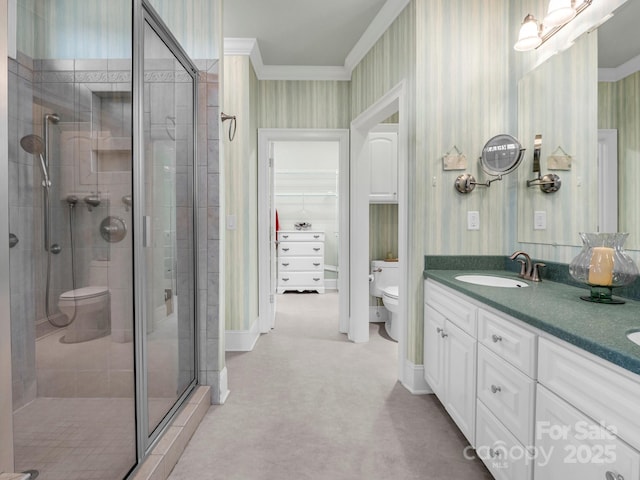 bathroom featuring vanity, ornamental molding, an enclosed shower, and toilet