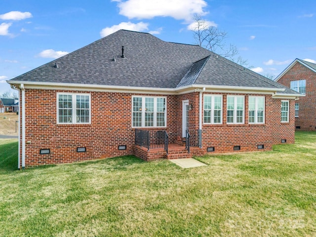 rear view of house featuring a yard