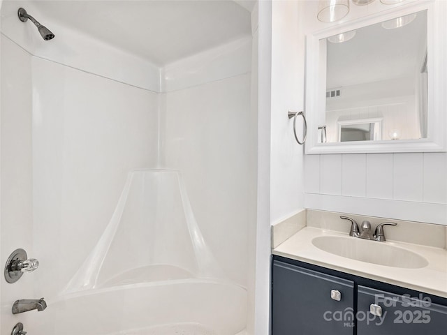 bathroom featuring vanity, visible vents, and shower / bathtub combination