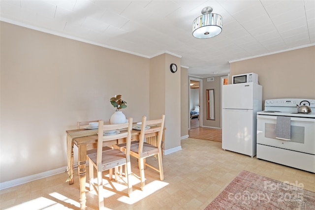 dining area featuring crown molding