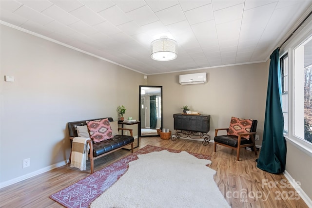 living area with crown molding, light wood-type flooring, and a wall unit AC