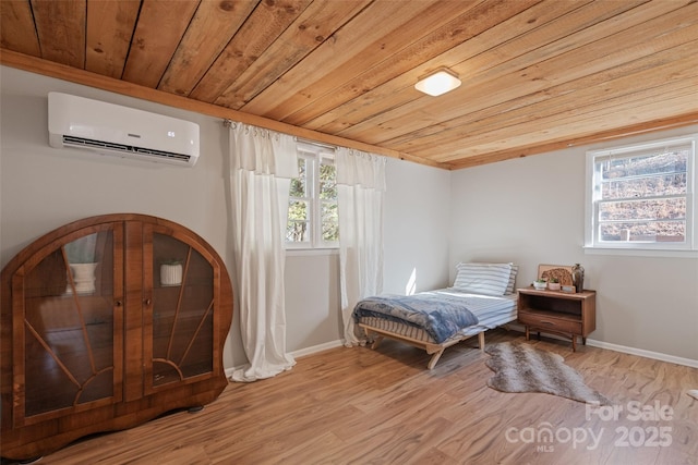 bedroom featuring wood ceiling, light hardwood / wood-style floors, and a wall mounted AC