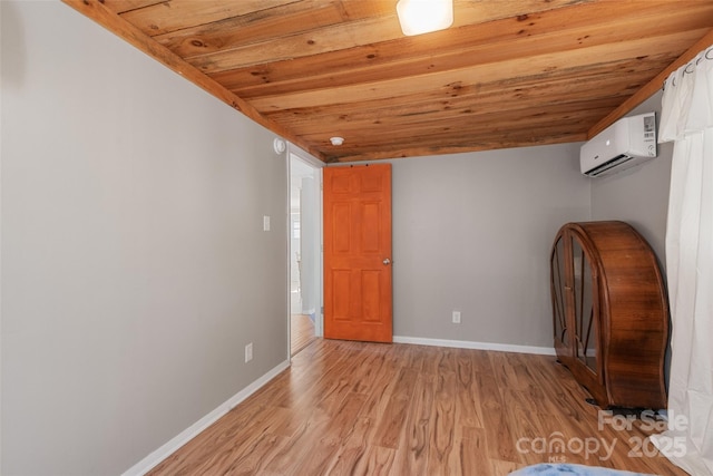 interior space with a wall mounted AC, light wood-type flooring, and wooden ceiling