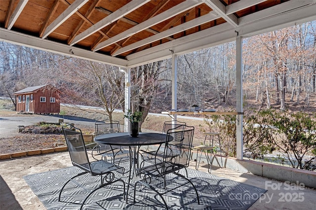 view of patio / terrace featuring a gazebo and a storage unit