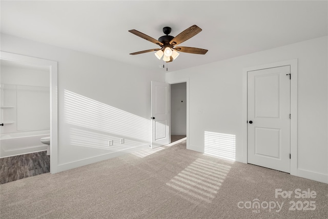 carpeted spare room with ceiling fan