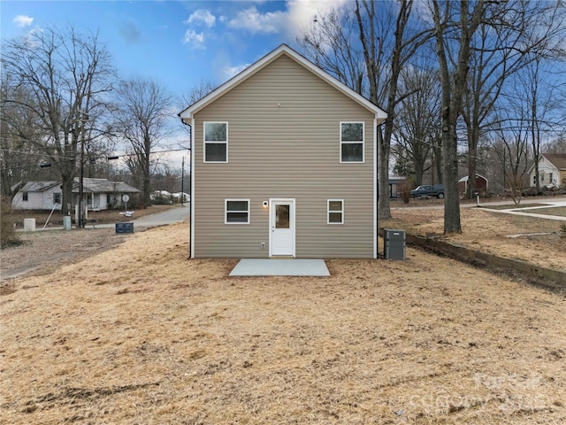 rear view of property featuring a patio and cooling unit