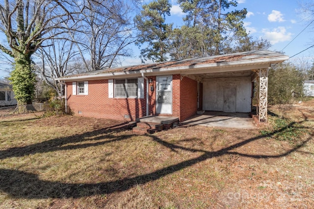 single story home featuring a front yard and a carport