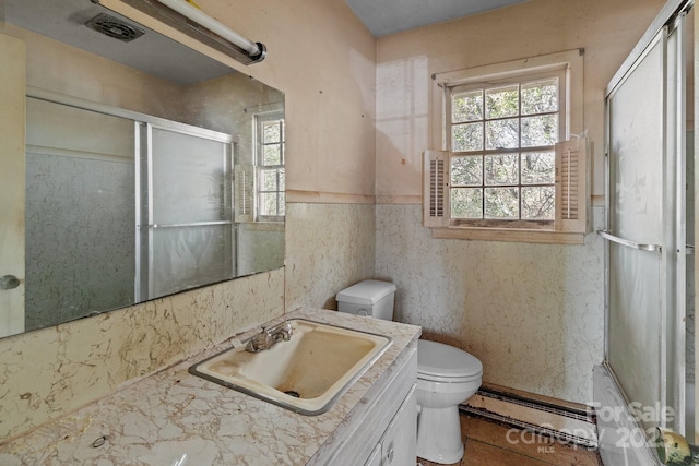 bathroom with vanity, a baseboard heating unit, walk in shower, and toilet