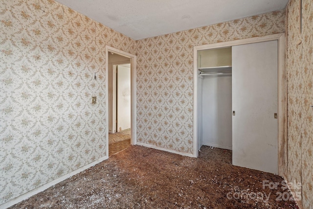 unfurnished bedroom featuring a closet and a textured ceiling