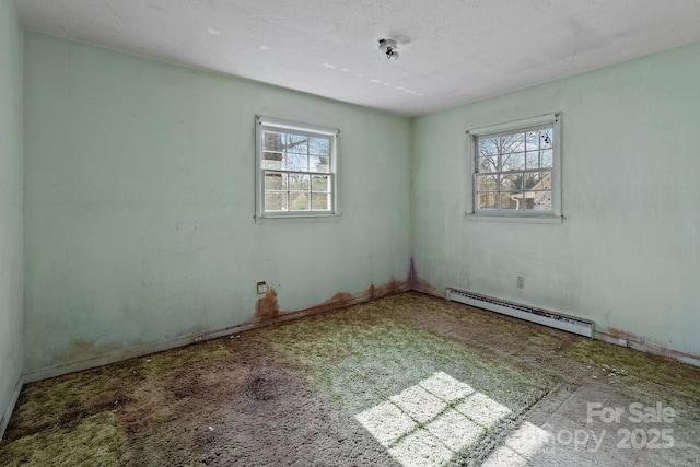 empty room with plenty of natural light and a baseboard heating unit