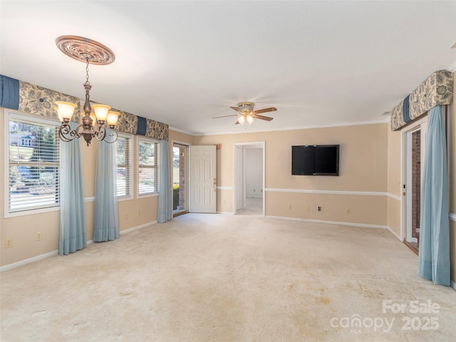 unfurnished living room featuring baseboards, light carpet, crown molding, and ceiling fan with notable chandelier