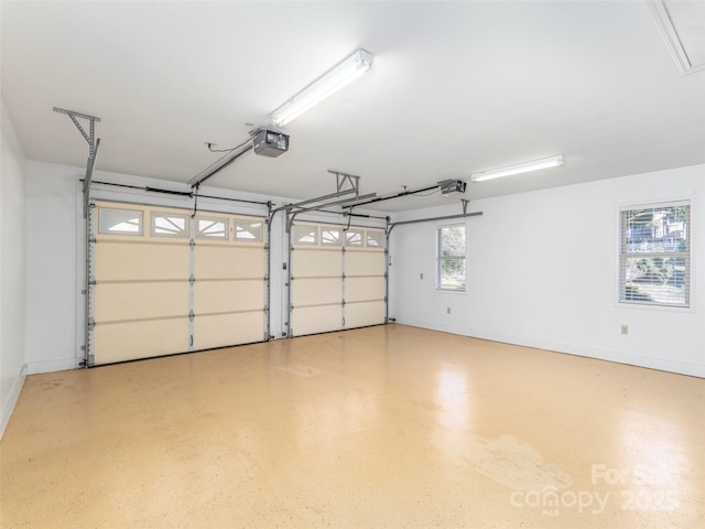 garage with baseboards and a garage door opener