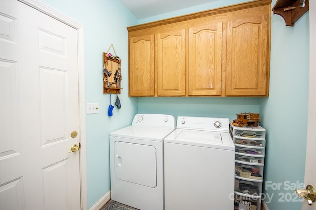 laundry area with cabinets and washer and clothes dryer