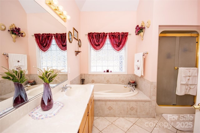 bathroom featuring tile patterned floors, shower with separate bathtub, and vanity