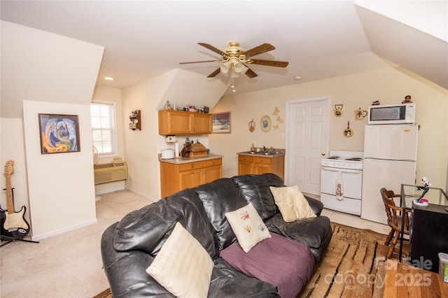 living room with lofted ceiling, sink, light colored carpet, and ceiling fan