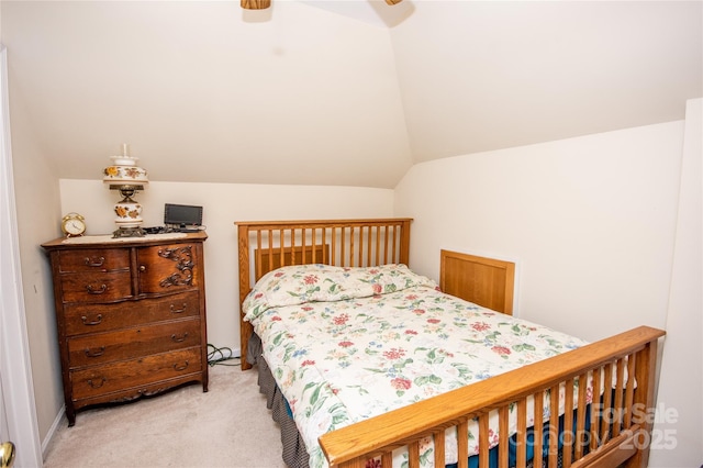 bedroom featuring ceiling fan, lofted ceiling, and light carpet