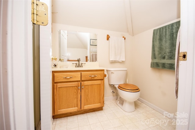 bathroom featuring lofted ceiling, vanity, and toilet