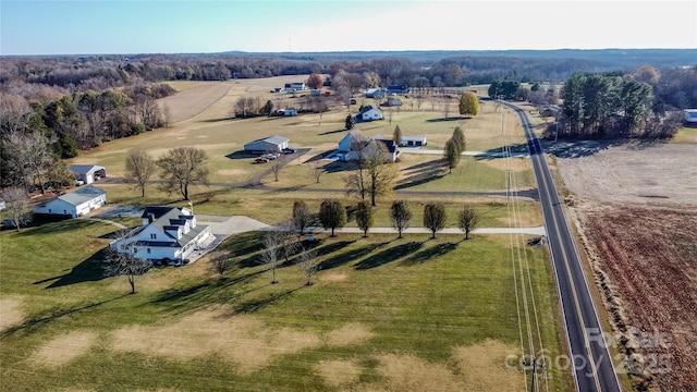 birds eye view of property with a rural view