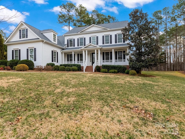 view of front facade featuring a front yard and covered porch