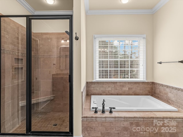 bathroom featuring ornamental molding and separate shower and tub