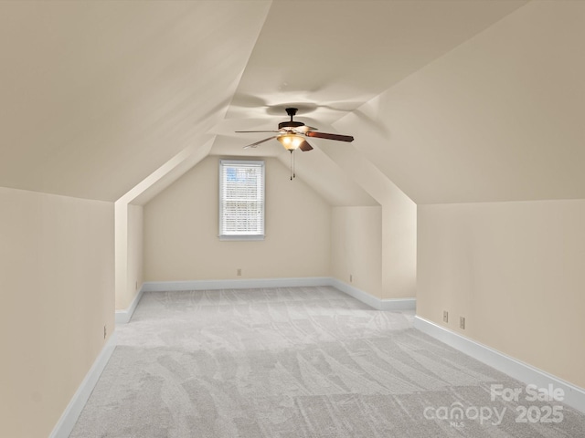 bonus room featuring ceiling fan, lofted ceiling, and light carpet