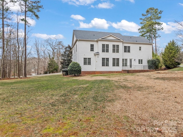 rear view of house with a yard