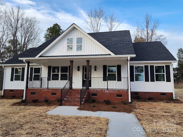 view of front of home with crawl space, a porch, and a shingled roof