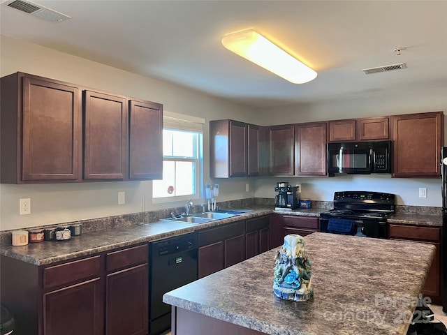 kitchen featuring dark brown cabinets, sink, a kitchen island, and black appliances