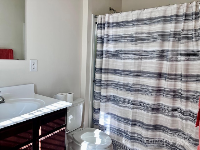 bathroom featuring vanity, a shower with shower curtain, and toilet