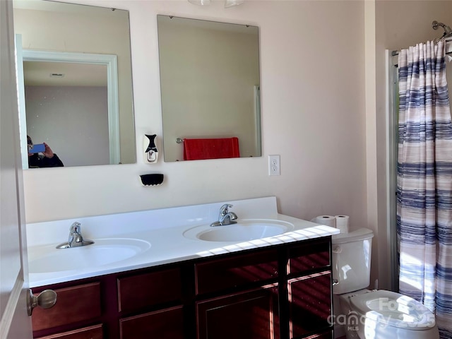 bathroom featuring vanity and toilet