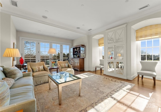 living room featuring crown molding and light wood-type flooring