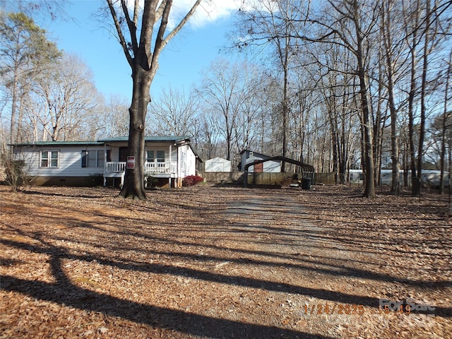 view of yard with a carport and covered porch